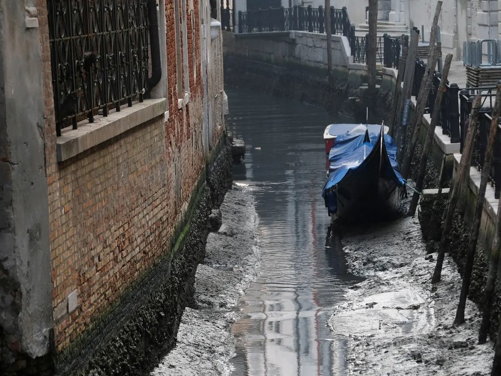 Một chiếc thuyền gondola tr&ecirc;n con k&ecirc;nh cạn nước ở Venice. Ảnh: Reuters